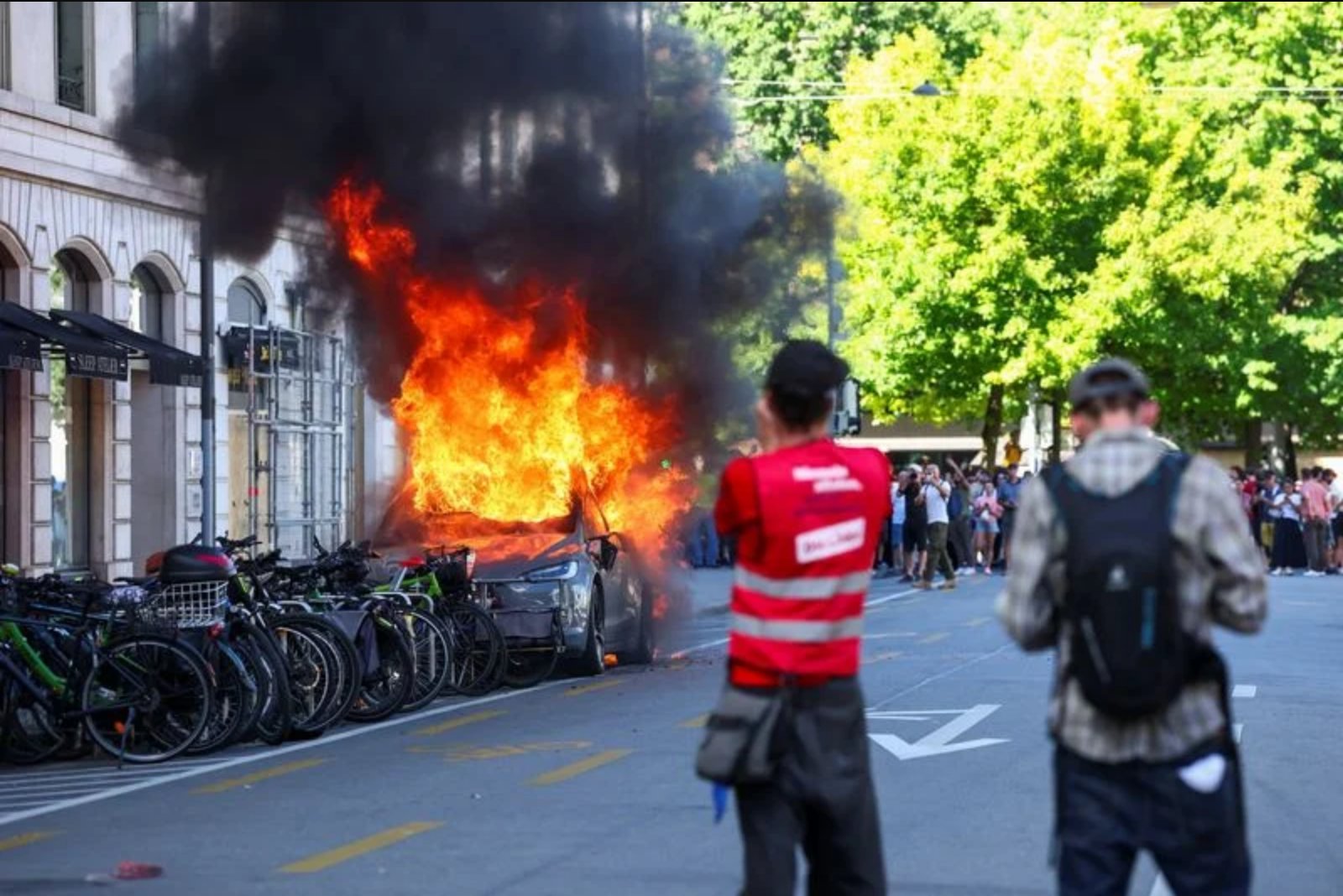 Anger at G7 Sparks Damage in Geneva as Protesters Burn Tesla and Smash Bank Windows
